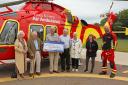 Raised - organisers Pat Hughes, Mac Beanland, Richard Hughes and David and Primrose Hunt with Clair Mitchell and a paramedic crew member