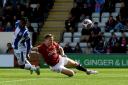 Balancing act - Owura Edwards in action for Colchester United at Morecambe