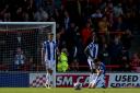 Sinking feeling - Colchester United's players look dejected after ten-man Morecambe fought back to snatch a draw