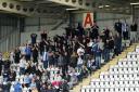 Support - Colchester United fans cheer on their team at Morecambe