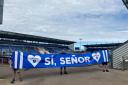 Backing - Colchester United fans show off a banner in support of striker Samson Tovide, following an incident of alleged racist abuse