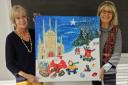 Home-Start Winchester trustee Chrissie Barlow with artist Daphne Vaughan show off this year’s charity Christmas card