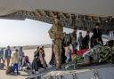 British citizens and dual nationals residing in Afghanistan boarding an RAF plane before being relocated to the UK