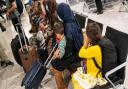 Refugees from Afghanistan wait to be processed after arriving on an evacuation flight at Heathrow Airport.