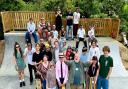 Cllr Martin Foley, front row with hands in the air, with members of Thaxted Youth Club at the opening of the new skatepark