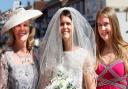 Farleigh Hospice charity shop in Great Dunmow is focussed on wedding and prom related items. Debbie de Boltz in a Mother of the bride dress £20, hat £6.50. Caroline Smith in a Bride's dress £200 (new with tags). Mia Smith in a Bridesmaid dress £20.