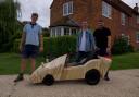 Jordan Bright (centre) with the bespoke wooden soapbox