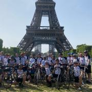 Fundraising cyclists for Kids Inspire arrive at the finish life of the Eiffel Tower, Paris