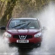 Cars make their way through flood water near Chediston in Suffolk. Picture: JOE GIDDENS/PA WIRE