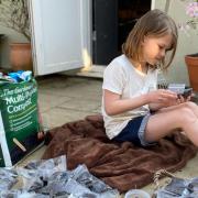 Jessica Mills packing up the soil and sunflower seeds