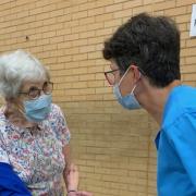 Dora Hunter discusses with Dr Emma Pugh of Thaxted surgery about having the Covid vaccine booster and prepares to receive it at the Lord Butler Leisure Centre, Saffron Walden