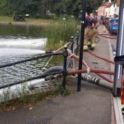 Fire crews from Dunmow pumping the pond after blue-green algae bloomed in the water