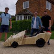 Jordan Bright (centre) with the bespoke wooden soapbox