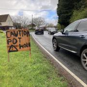 The makeshift pothole warning sign