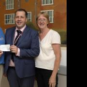 David Beedle presented a cheque to musical director James Cairns, treasurer Gerry Bassingthwaighte and chair Lucy Myers