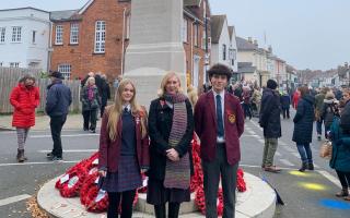 Headteacher Catherine Davis at the war memorial with pupils Michaela and Deniz