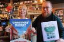 Community -  Nick and Victoria May in the Alma with the final Little Pub Book on the Swan and a poster for the Kings Head Street Christmas Market, where the book will be on sale