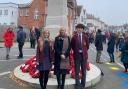 Headteacher Catherine Davis at the war memorial with pupils Michaela and Deniz