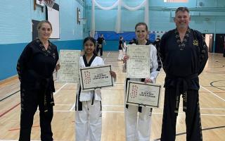 Black belts Shriya Patel and Bryony Arnold between Dunmow TKD  instructors Cheyl and Matt Howard. Picture: DUNMOW TKD